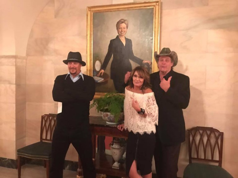 Former Alaska Gov. Sarah Palin reunited with President Trump at the White House on Wednesday. Ted Nugent, Kid Rock and Palin stand in front of a portrait of Hillary Clinton.