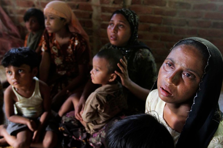   A Rohingya Muslim family who fled Myanmar to Bangladesh to escape religious violence sits at a shelter provided by local people in Taknaf, Bangladesh, Tuesday, June 12, 2012. Bangladesh on Tuesday turned away three boats carrying 1,000 Rohingya Muslims fleeing violence in neighboring Myanmar, bringing to 1,500 the number of refugees blocked in recent days, officials said. (AP Photo/Anurup Titu)  