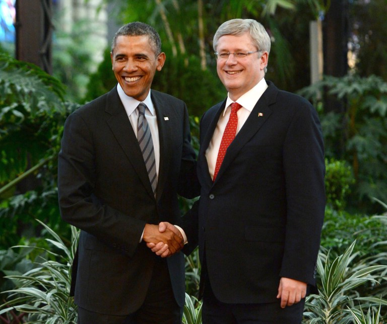 In this Feb. 19, 2014, photo Canada's Prime Minister Stephen Harper, right, shakes hands with President Barack Obama during the North American Leaders Summit in Toluca, Mexico. Harper is ready for the icy cold one Obama promised him. With their countries facing off in a pair of Olympic hockey games this week, more than just the puck was on the line. The leaders wagered a case of beer on each game.  (AP Photo/The Canadian Press, Sean Kilpatrick )