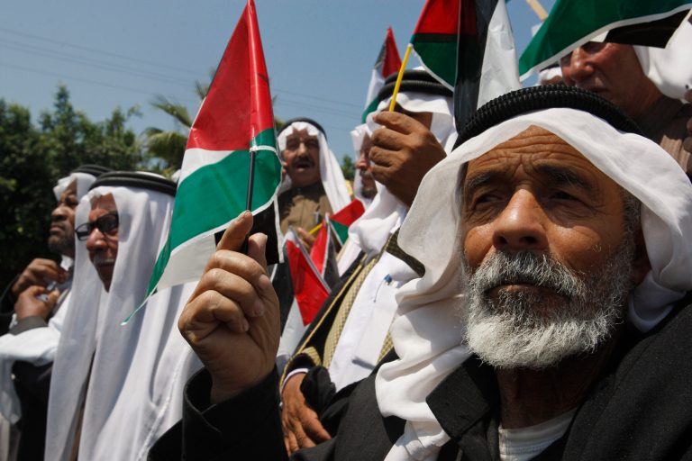 FILE - In this Wednesday, May 11, 2011 file photo, Palestinians wave flags as they celebrate the reconciliation between rival factions Fatah and Hamas, during a rally in Gaza City. President Mahmoud Abbas said a dark period in Palestinian history has ended with the formation of a unity government that formally ends his seven-year rift with the Islamic militant Hamas. But the alliance of old foes remains volatile, while Israel threatens punitive measures and Abbas doesn't know yet if he'll get continued financial aid from the U.S. and Europe to keep the unity government afloat. (AP Photo/Hatem Moussa, File)