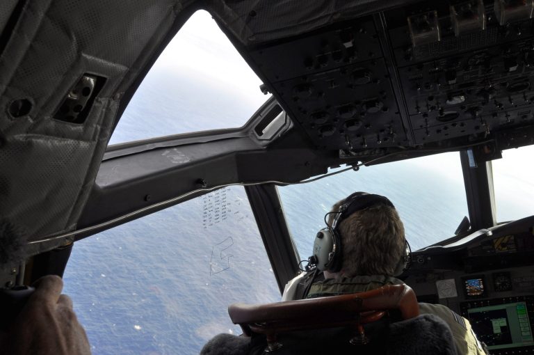 In this , Tuesday, April 1, 2014 photo made available Thursday, April 3, 2014, a crewman on a Royal New Zealand Air Force P-3 Orion Rescue Flight 795 searches for debris from the missing Malaysia Airlines Flight MH370, in southern Indian Ocean, 1,500 kilometers northwest of Perth, Australia. The focus of the search has changed repeatedly in the nearly four weeks since the air traffic controllers lost contact with the Boeing 777 between Malaysia and Vietnam over the South China Sea. It began in the South China Sea, then shifted toward the Malacca Strait to the west, where Malaysian officials eventually confirmed that military radar had detected the plane. (AP Photo/AAP Image, Kim Christian, POOL)
