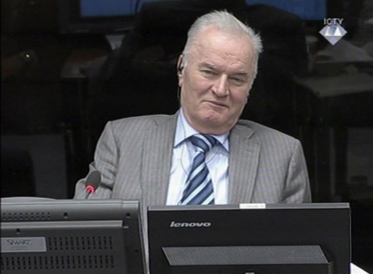 FILE - In this Jan. 28, 2014 file image taken from video former Bosnian Serb military chief Gen. Ratko Mladic smiles during his appearance at the Yugoslav war crimes tribunal in the Hague, Netherlands. On Monday, May 19, 2014 Mladic has launched the defense case in his long-running U.N. trial by calling a former Serb army officer who claims he was never ordered to fire on civilians in the besieged Bosnian capital. The 72-year-old Mladic denies 11 charges of ordering Serb atrocities throughout the 1991-95 Bosnian war. He faces a life sentence if convicted. (AP Photo/ICTY, Via Associated Press Television, File) TV OUT