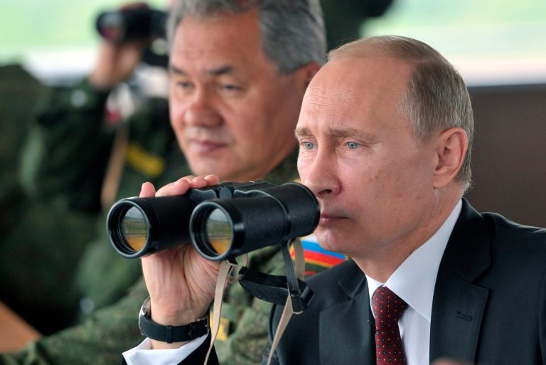 FILE - In this Tuesday, July 16, 2013 file photo Russian President Vladimir Putin, flanked by Defense Minister Sergei Shoigu, uses binocular as he watches military exercise near Yuzhno-Sakhalinsk, on Sakhalin Island, Russia. President Vladimir Putin on Wednesday, Feb. 26, 2014, ordered massive exercises involving most of its military units in western Russia amid tensions in Ukraine.  (AP Photo/RIA Novosti, Alexei Nikolsky, Presidential Press Service, Pool)