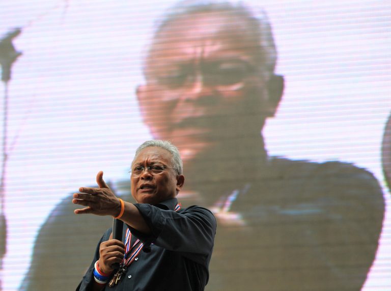 Anti-government protest leader Suthep Thaugsuban speaks to supporters in Bangkok, Thailand, Thursday, Feb. 27, 2014. Thailand's anti-graft commission on Thursday summoned the embattled prime minister to hear charges of negligence for allegedly mishandling a government subsidy program, as her supporters blocked access and chain-locked one of the gates to the agency's headquarters in Bangkok's outskirts. (AP Photo/Sakchai Lalit)