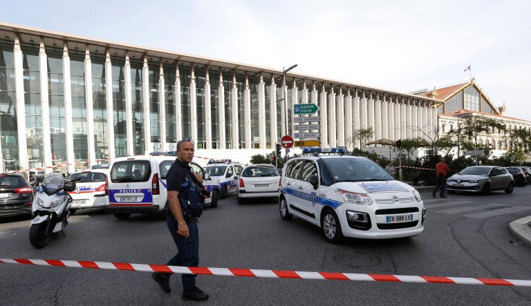 A French police officer cordons off the access to Marseille's main train station Sunday. (AP Photo/Claude Paris)