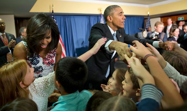 President Obama and first lady Michelle Obama greet children and families of U.S. embassy personnel in Havana, Cuba. Obama's trip is a crowning moment in his and Cuban President Raul Castro's ambitious effort to restore normal relations between their countries. (AP Photo/Pablo Martinez Monsivais)