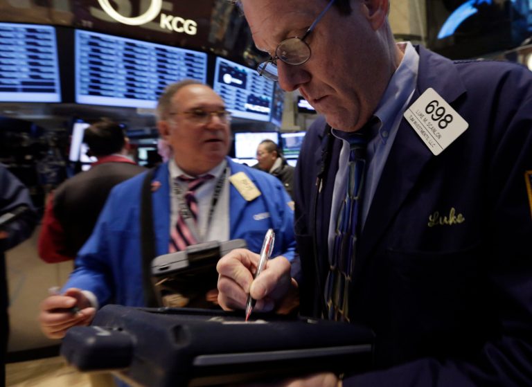 Trader Luke Scanlon, right, works on the floor of the New York Stock Exchange Wednesday, Jan. 29, 2014. Stocks are lower in early trading as weak earnings from several U.S. companies dented investors' confidence. Worries about emerging markets were also coming back after relief faded over an effort by Turkey to shore up its struggling currency. (AP Photo/Richard Drew)