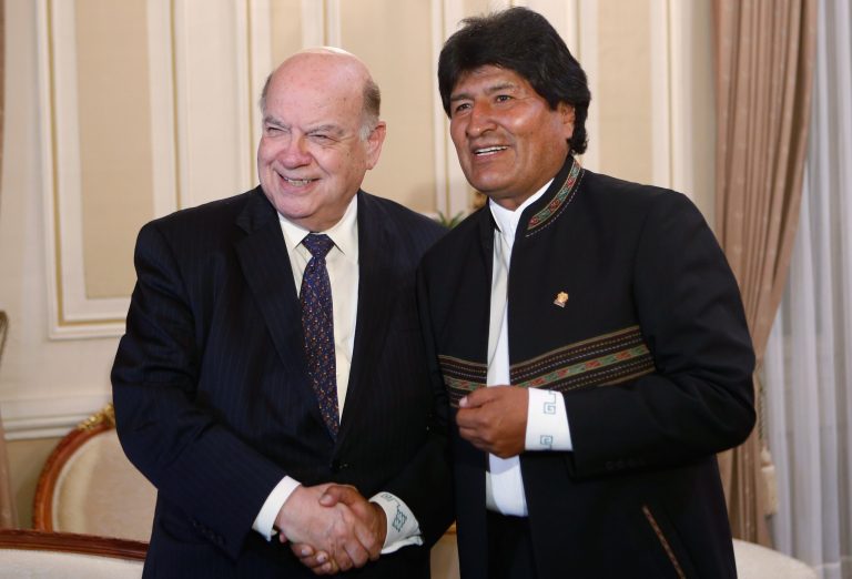 Bolivia's President Evo Morales (right) shakes hands with current Secretary General of the OAS Jose Miguel Insulza (left). [AP Photo