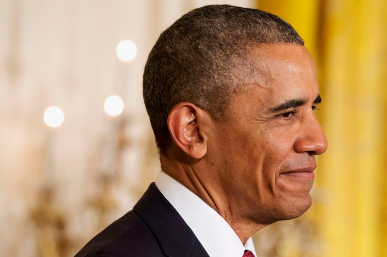 President Obama smiles at new citizens during a naturalization ceremony for active duty service members and civilians Friday in the East Room of the White House in Washington. (AP/Jacquelyn Martin)