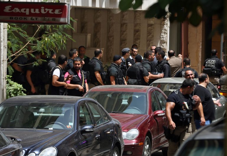 Lebanese police intelligence gather outside a hotel after security forces raided there in Beirut's Hamra district, Lebanon, Friday, June 20, 2014. Security forces raided the hotel over suspected 