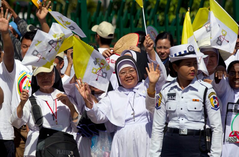 Myanmar Christians wave as they see off Pope Francis at Yangon International Airport in Yangon, Myanmar Thursday, Nov. 30, 2017. Francis wrapped up his visit to Myanmar on Thursday with a Mass for young people before heading to neighboring Bangladesh where the Muslim Rohingya refugee crisis was expected to take center stage. (AP Photo/Thein Zaw)