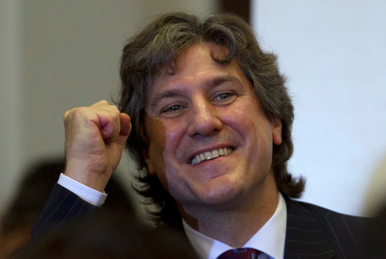 FILE - Argentina's Vice President Amado Boudou gestures as he arrives to a ceremony in Buenos Aires, Argentina, in this May 4, 2012 file photo. An Argentine judge has charged Vice President Amado Boudou Friday June 27, 2014 with bribery and conducting business incompatible with public office in the acquisition of the company that prints the country's currency and of later benefiting from government contracts.   (AP Photo/Natacha Pisarenko, File)