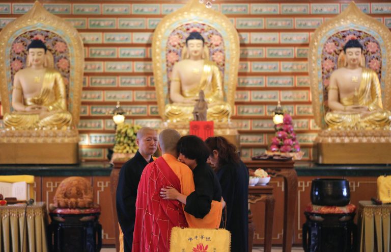 A Chinese relative of passengers on board the missing Malaysia Airlines Flight MH370 is comforted by a monk as she breaks into tears following prayers at a Buddhist temple in Petaling Jaya, Malaysia, Monday March 31, 2014. Relatives from China are in the country to seek answers of what happened to their loved one on board flight MH370. (AP Photo/Aaron Favila)