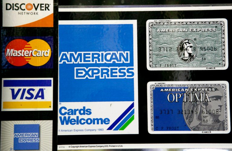 FILE - In this Sept. 5, 2007 file photo, credit card decals adorn a store window in the Hollywood section of  Los Angeles. The Federal Reserve reports on consumer borrowing data for June 2014 on Thursday, Aug. 7, 2014. (AP Photo/Nick Ut, File)