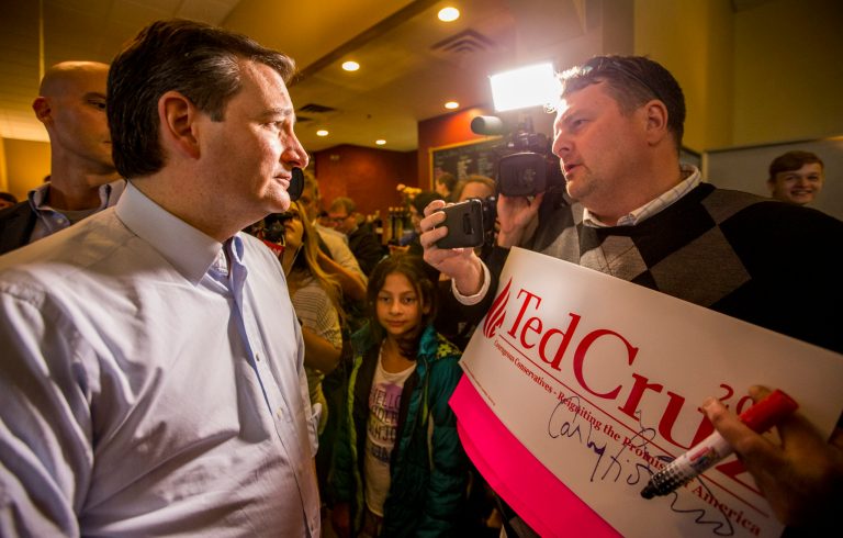 The GOP presidential candidate signed his name, but only after scribbling a note for the owner. (Robert Franklin/South Bend Tribune via AP)