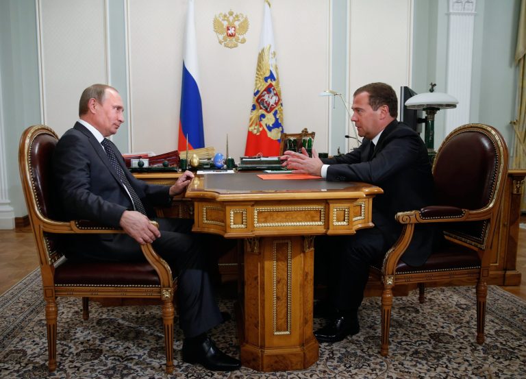 Russian President Vladimir Putin listens to Russian Prime Minister Dmitry Medvedev, right, at the Novo-Ogaryovo residence outside Moscow on Monday, Sept 8, 2014. (AP Photo/RIA Novosti, Dmitry Astakhov, Government Press Service)