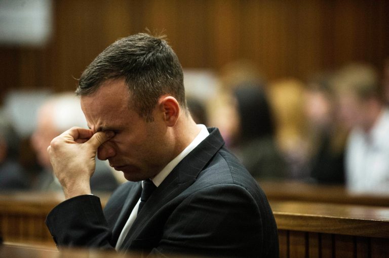 Oscar Pistorius reacts as he  listens to forensic evidence being given in court in Pretoria, South Africa, Wednesday, April 16, 2014.  Pistorius is charged with the murder of his girlfriend, Reeva Steenkamp, on Valentines Day in 2013. (AP Photo/Gianluigi Guercia, Pool)