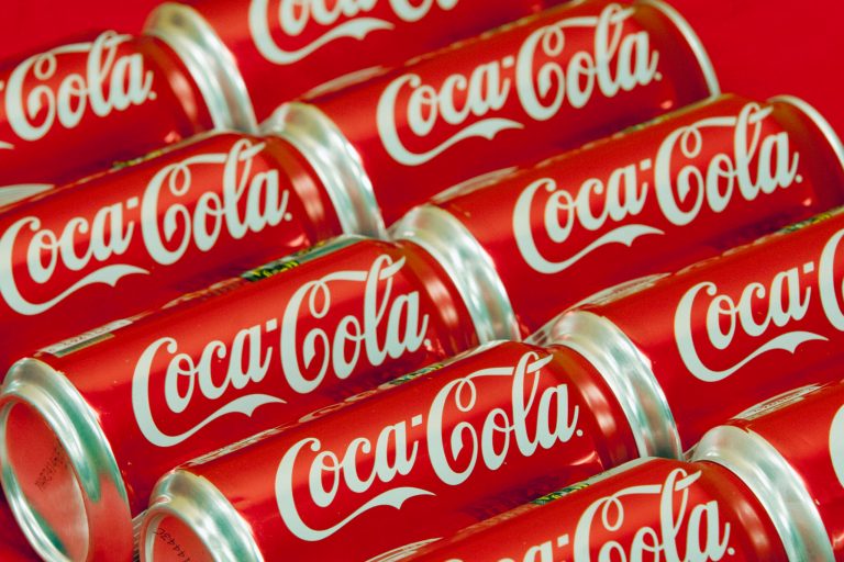 This July 15, 2013 file photo shows cans of Coca-Cola in Doral, Florida. Coca-Cola is taking on obesity, this time with an online video showing how fun it could be to burn off the 140 calories in a can of its soda.