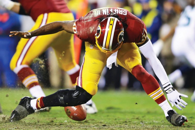 Al Bello/Getty Images
Robert Griffin III's knee gave out as he reached to pick up a bad snap in the fourth quarter of the Redskins' loss to the Seahawks on Sunday.