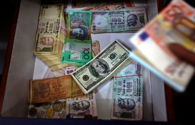 FILE - In this Aug. 22, 2013 file photo, Indian and foreign currency notes lie in a drawer of a foreign currency exchange shop in Bangalore, India. The Treasury Department reports how much foreign buyers adjusted their holdings of U.S. debt in June 2014 on Friday, Aug. 15, 2014. (AP Photo/Aijaz Rahi, File)