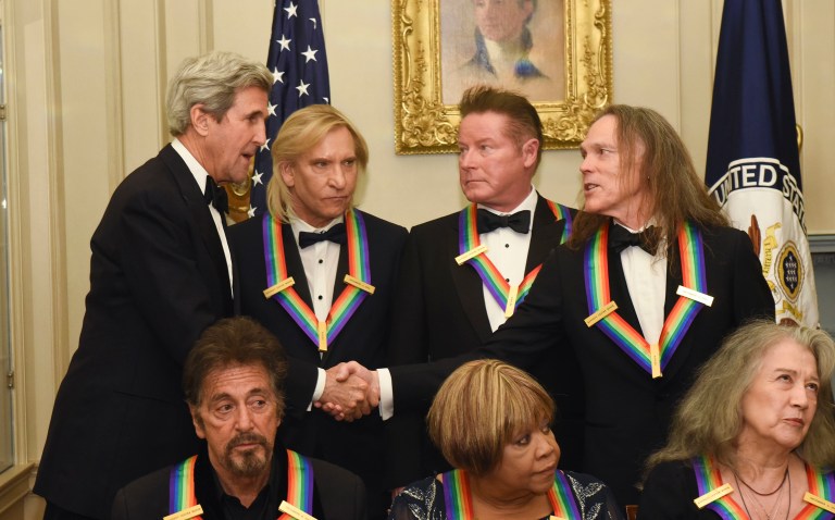 Secretary of State John Kerry, top left, meets with Eagles members including Joe Walsh, second left. (AP Photo/Kevin Wolf)