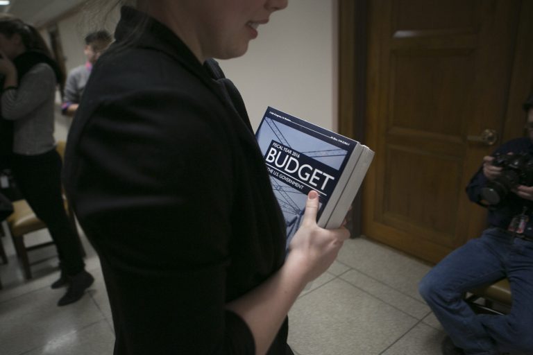 A Congressional staffer carries a copy of President Obama's new fiscal 2016 $4 trillion budget plan on Capitol Hill in Washington, Monday, Feb. 02, 2015. (Graeme Jennings/Examiner)
