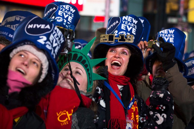 Olga Lovchu, of Chicago, center right, cheers in Times Square for the New Year's Eve celebration, Monday, Dec. 31, 2012, in New York. This will be the first Times Square countdown in decades without Dick Clark, who died in April, and will be honored with a tribute concert and his name printed on pieces of confetti. (AP Photo/John Minchillo)