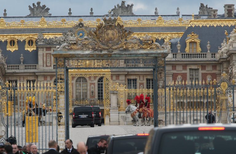 Fans gather to watch guests arriving, as they look inside one of the cars for Kim Kardashian, Kanye West and their guests, at the entrance  of the Chateau de Versailles  in Versailles, France, west of Paris, Friday, May 23, 2014.  The gates of the Chateau de Versailles, once the digs of Louis XIV, will be thrown open to Kim Kardashian, Kanye West and their guests for a private evening on the eve of their marriage. (AP Photo/Jacques Brinon)