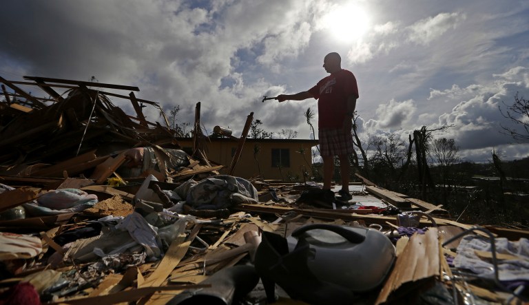 Jose Garcia Vicente holds a piece of plumbing he picked up, as he shows his destroyed home, in the aftermath of Hurricane Maria, in Aibonito, Puerto Rico, Monday, Sept. 25, 2017. The U.S. ramped up its response Monday to the humanitarian crisis in Puerto Rico while the Trump administration sought to blunt criticism that its response to Hurricane Maria has fallen short of it efforts in Texas and Florida after the recent hurricanes there. (AP Photo/Gerald Herbert)