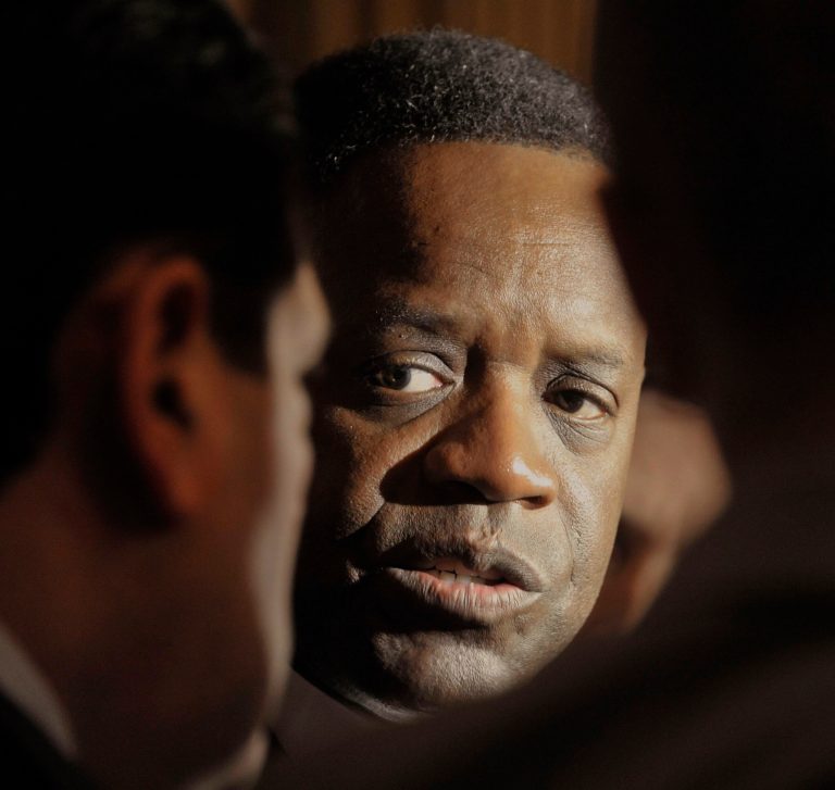 Detroit Emergency Manager Kevyn Orr, center, talks with media outside the Governor's office at the Michigan Capitol, Tuesday, April 29, 2014, in Lansing, Mich. (AP Photo/The Detroit News, Dale G. Young)