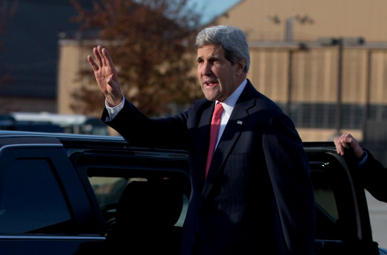Secretary of State John Kerry waves before getting into his motorcade vehicle as he arrives at Andrews Air Force Base, Md., Monday, Nov. 25, 2013, as he returns from London. While in London Kerry had meetings with Libyan's Prime Minister Ali Zeidan and British Foreign Secretary William Hague. Prior to London, Kerry was in in Geneva, Switzerland, for the Iran nuclear talks.  European Union sanctions against Iran could be eased as soon as December, officials said Monday, after a potentially history-shaping deal that gives Tehran six months to increase access to its nuclear sites in exchange for keeping the core components of its uranium program. (AP Photo/Carolyn Kaster, Pool)