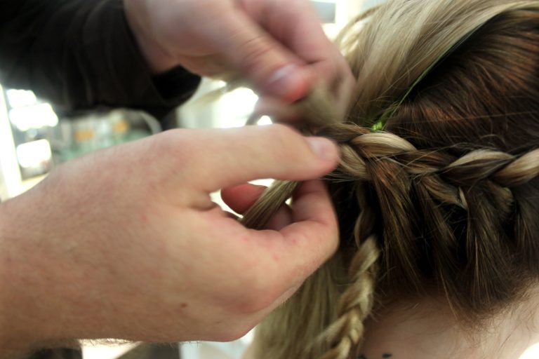In this Aug. 1, 2012 photo, stylist Cliff Freeman braids the hair of Danielle Maddox, 25, at Maxine salon's Braid Bar in Chicago. (AP Photo/Caryn Rousseau)