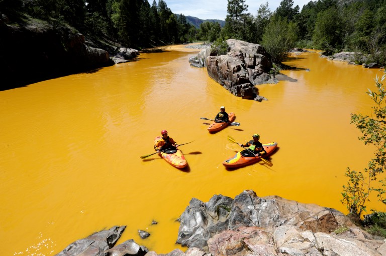 People kayak in the Animas River near Durango, Colo., Aug. 6, 2015, in water colored from a mine waste spill. (Jerry McBride/The Durango Herald via AP)