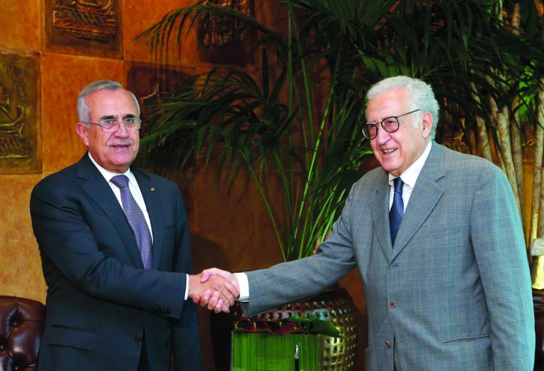 In this photo released by Lebanon's official government photographer Dalati Nohra, Lebanese President Michel Suleiman, left, shakes hands with U.N.-Arab League envoy for Syria, Lakhdar Brahimi, at the Lebanese presidential palace, in Baabda east of Beirut, Lebanon, Wednesday, Oct. 17, 2012. Brahimi is in Beirut to meet with Lebanese officials. (AP Photo/Dalati Nohra, HO) EDITORIAL USE ONLY, NO SALES