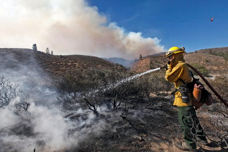 Nick Ut/AP
Justin Rendich, a firefighter from Santa Clarita, hoses a hot spot at a wildfire in Lancaster, Calif., earlier this month.