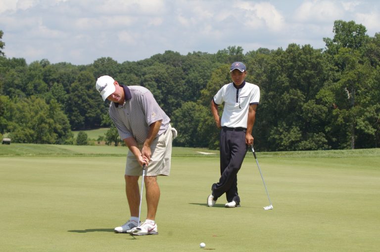  In Tuesday's U.S. Amateur qualifier at the University of Maryland, Ji Soo Park of Fairfax watched his coach at the UNiversity of Virginia, Bowen Sargent, sink a birdie putt on the 18th hole. / Photo by Kevin Dunleavy 