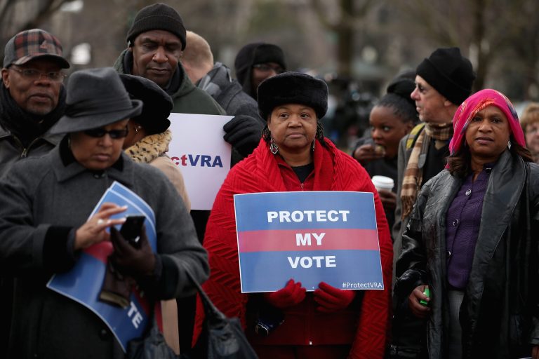 Residents of Shelby County, Ala., protest the county's challenge to the constitutionality of part of the Voting Rights Act at the Supreme Court earlier this year. (Chip Somodevilla/Getty Images)