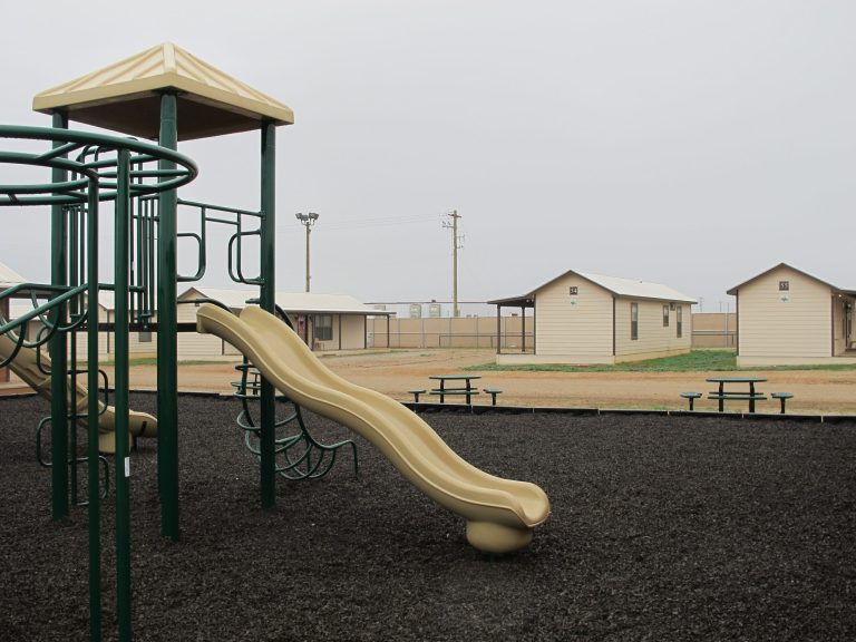 A playground surrounded by cottages that house immigrants at a family immigration detention center in Dilley, Texas. (AP Photo/Will Weissert)