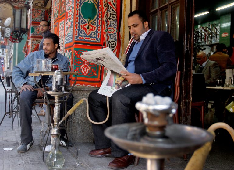   An Egyptian man reads a newspaper at a coffee shop in Cairo, Egypt, Sunday, Dec. 23, 2012. Egypt's opposition called Sunday for an investigation into allegations of vote fraud in the referendum on a deeply divisive Islamist-backed constitution after the Muslim Brotherhood, the main group backing the charter, claimed it passed with a 64 percent 