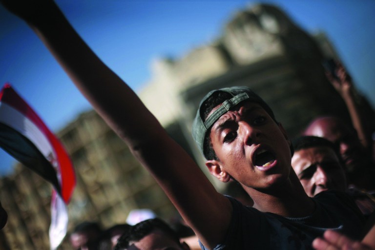 An Egyptian protester chats anti-Supreme Council for the Armed Forces (SCAF) slogans in Tahrir Square, Cairo, Egypt, Thursday, 21 June, 2012. Authorities delayed Thursday's planned announcement of the winner of Egypt's presidential election. Hundreds of Brotherhood supporters camped out in Cairo's Tahrir Square on Wednesday night, denouncing the ruling military and vowing to stay in place until the parliament, which was dissolved last week on a court order, is reinstated. (AP Photo/Manu Brabo)