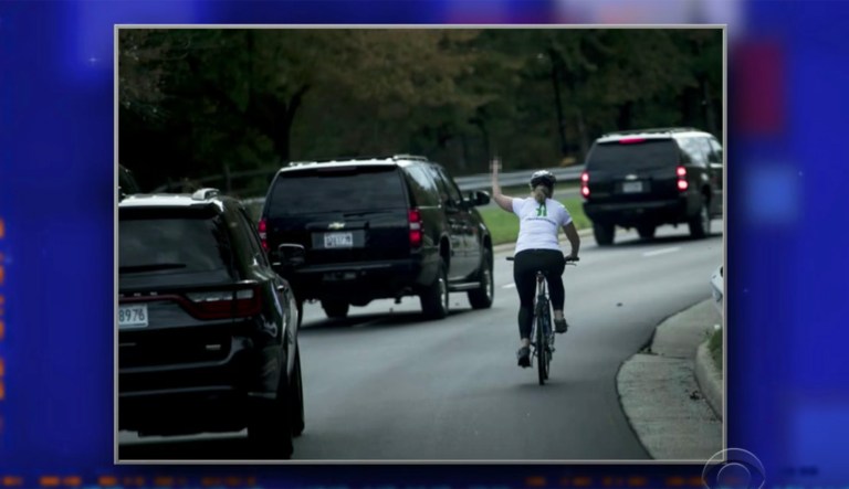 A woman who flipped off President Trump's motorcade was fired from her job at a government contractor. Juli Briskman said her bosses told her she had violated the company's social media policy by making the image her profile picture on Facebook and Twitter. (Screenshot/The Late Show with Stephen Colbert)