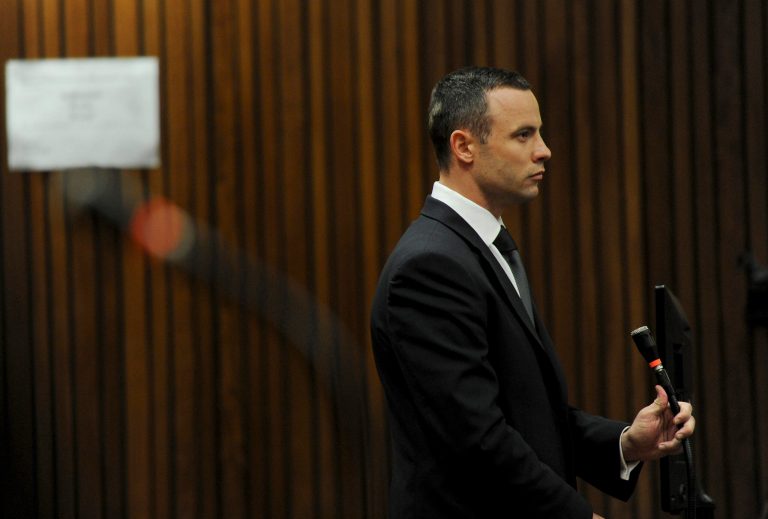 Oscar Pistorius stands in the dock at the high court in Pretoria, South Africa, Wednesday, May 14, 2014. The judge overseeing the murder trial of Pistorius on Wednesday ordered the double-amputee athlete to undergo psychiatric tests, meaning that the trial proceedings will be delayed. The court adjourned until May 21, 2014. (AP Photo/Werner Beukes, Pool)