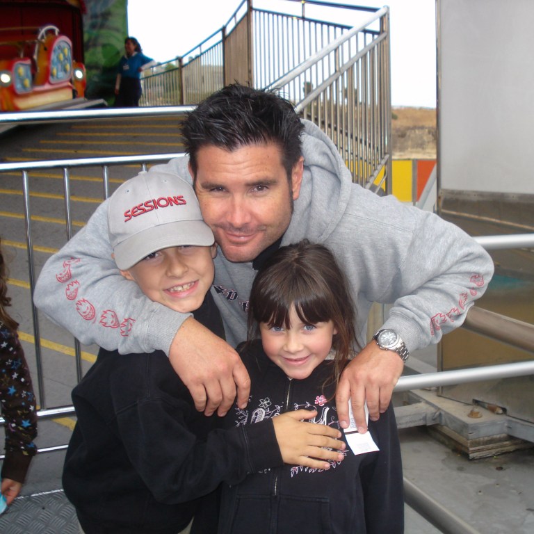 FILE - This undated file photo provided Tuesday April 5, 2011 by John Stow shows Bryan Stow holding his 12-year-old son and 8-year-old daughter. Bryan Stow a San Francisco Giants fan who suffered brain damage in a beating at Dodger Stadium won his negligence suit against the Los Angeles Dodgers on Wednesday, but former owner Frank McCourt  was absolved by the jury, Wednesday July 9, 2014.(AP Photo/John Stow, File)