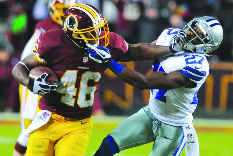 Richard Lipski/AP
Alfred Morris finished with 200 yards and three touchdowns and set the Redskins' single-season rushing mark with 1,613 yards.