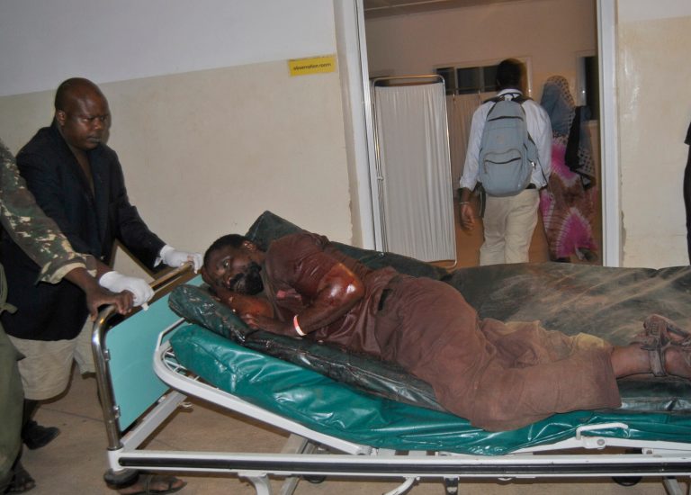 In this Friday, July 18, 2014 photo, a victim injured after an attack is carried on a stretcher to Malindi sub county hospital in Witu, Kenya. The Kenya Red Cross says seven people have been killed after gunmen attacked a bus along the Kenyan coast where previous attacks had left 87 people dead. The humanitarian group said Saturday the attack Friday night came at Corner Mbaya, 5 kilometers (3 miles) from the coastal town of Witu. Al-Qaida-linked al-Shabab militants from Somalia claimed responsibility for the attack. (AP Photo)