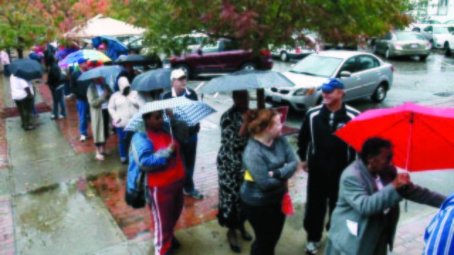 Voters wait in line despite rains from Hurricane Sandy to vote on the last early voting Sunday before election day, in New Bern, N.C., on Oct. 28, 2012. Early voting ends in Craven County on November 3. ((Byron Holland, New Bern Sun Journal/AP Photo)