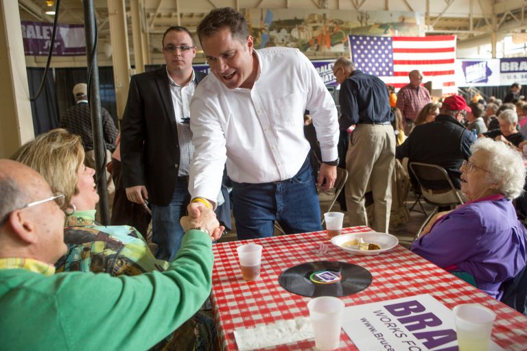 U.S. Senate candidate Bruce Braley talks to supporters Karen and Dennis Swallow of Waukee, Iowa during a barbecue lunch Sunday, Oct. 27, 2013, during the Bruce Blues & BBQ fundraiser for the Braley campaign at the Iowa State Fairgrounds in Des Moines, Iowa. (AP Photo/Scott Morgan)