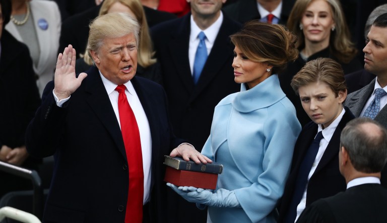 President Trump takes the oath of office as first lady Melania Trump stands during the 58th presidential inauguration. Trump's inaugural planning committee paid more than $25 million to a company owned by the first lady's personal friend and current adviser. (Andrew Harrer/Bloomberg)