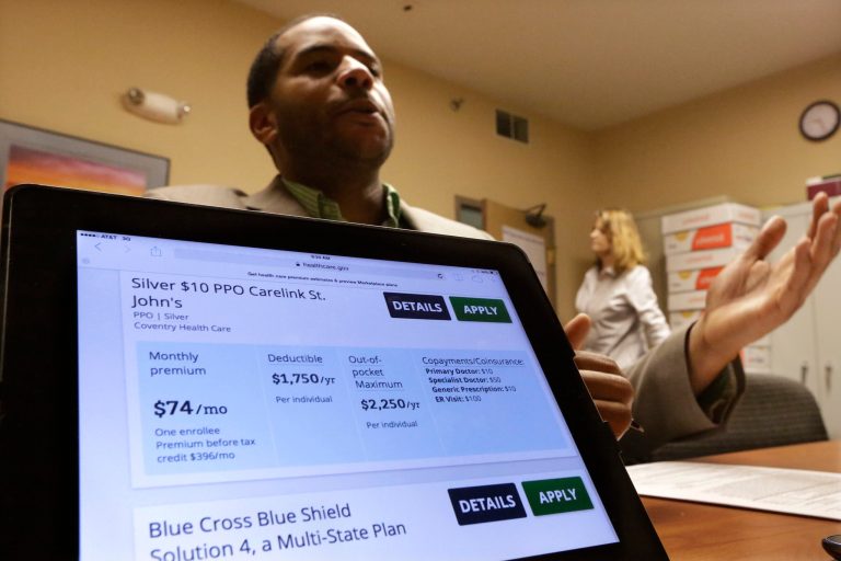 FILE - In this March 31, 2014 file photo, navigator John Jones explains the many options to a client seeking help buying health insurance at the Family Guidance Center in Springfield, Ill. The wild hikes in health insurance rates that blindsided many Americans in recent years may become less frequent because of the health care overhaul. (AP Photo/Seth Perlman, File)