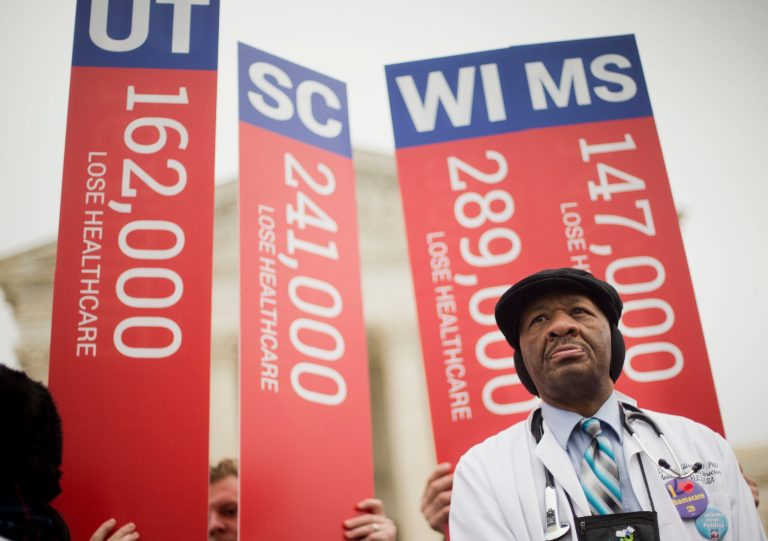 Dr. Tom Ellison, MD., PHD., from Birmingham, Ala. stands outside the Supreme Court in Washington, Wednesday, March 4, 2015, as the court hears arguments in King v. Burwell, a major test of President Barack Obama's health overhaul which, if successful, could halt health care premium subsidies in all the states where the federal government runs the insurance marketplaces. (AP Photo)